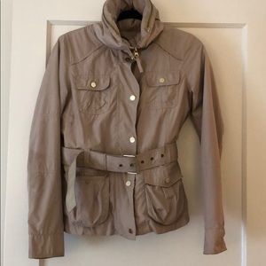 Tan rain jacket with belt and hidden hood